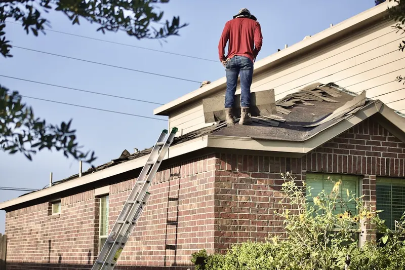 Professional roofer working on a residential roof in Sweetbriar